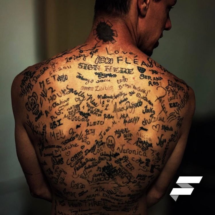 World record holder with the most tattoos on the back of a foreign man