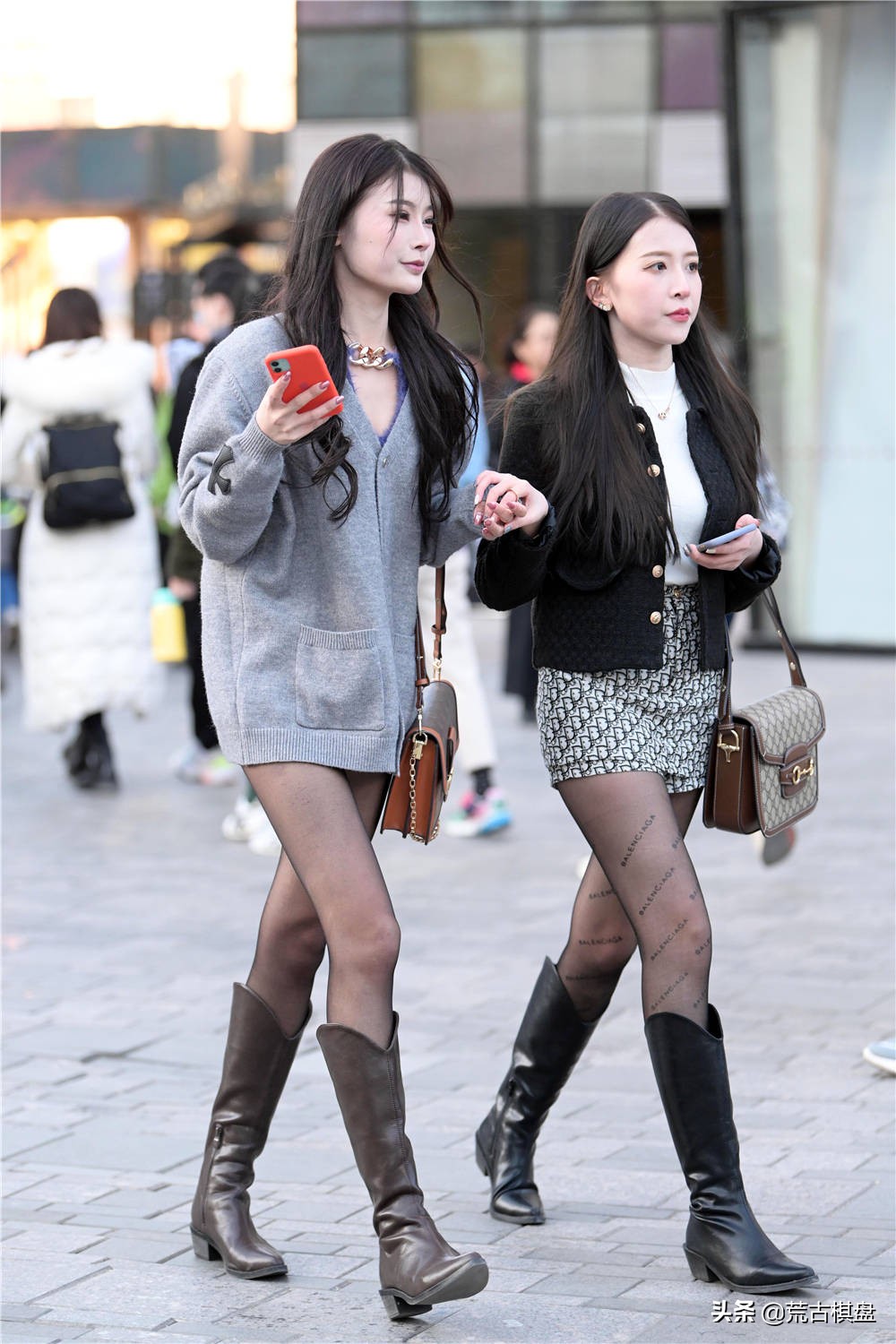 Black stockings are paired with cowboy boots. The two sisters are ...