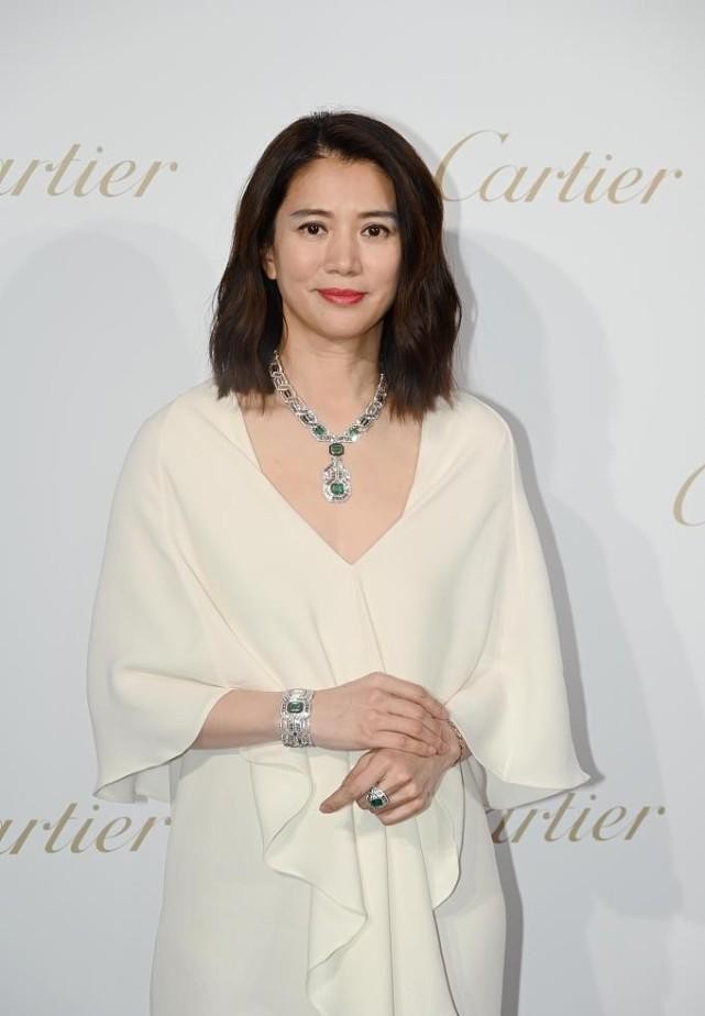 Anita Yuen dressed herself as Mrs. Kuo, wearing a white dress with jade ...