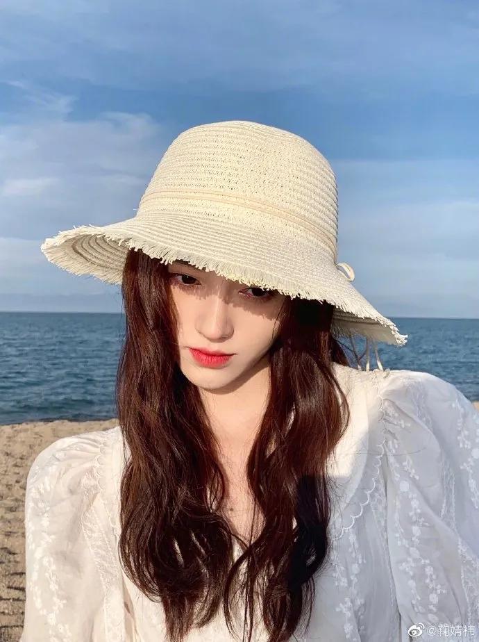 Ju Jingyi wore a white dress and walked along the beach with ...