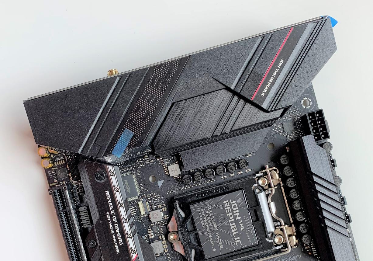 ASUS ROG STRIX B560i motherboard out of the box, with three B560i ...